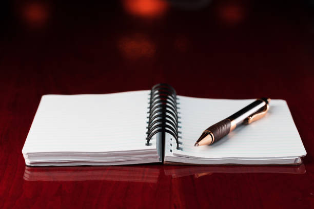 Ruled notebook and pen on an old desk