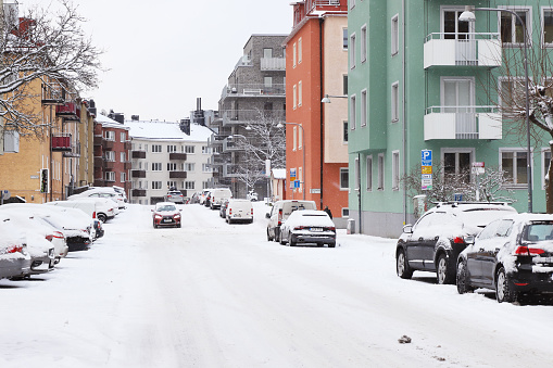 Sundbyberg, Sweden - January 14, 2021: View of the Vintergatan street in a residential area covered by snow.