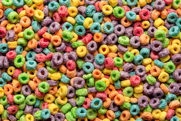 istock Colorful cereals background. Fruit flavored ring cereals full-frame 1308043966