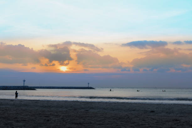 istock Shadow of beach people in summer at sunset 1308044011