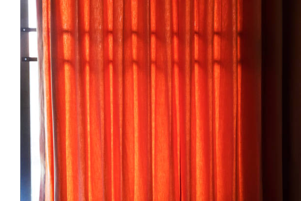 istock Curtain red of window with sunlight background banner interiors concept 1308044019