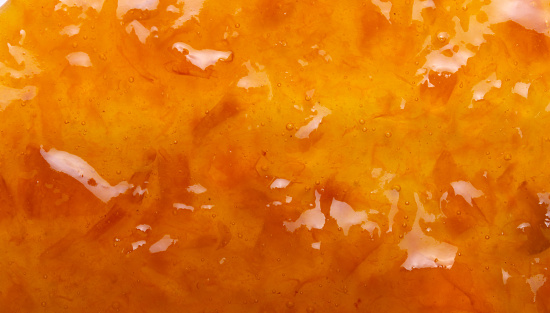 Delicious orange tasty jam texture close up