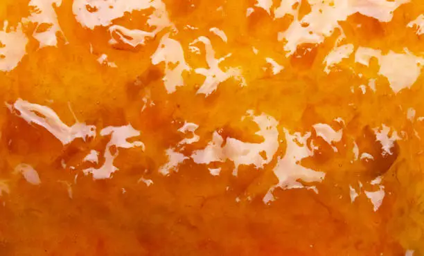 Photo of Delicious orange tasty jam texture background close up