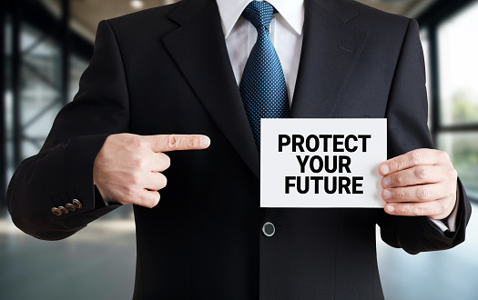 Businessman Shows A Card With The Message Protect Your Future Stock Businessman Shows A Card With The Message Protect Your Future Stock