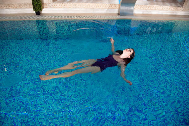 istock Cute girl is relaxing in the pool. Relax pool spa. 1308048273