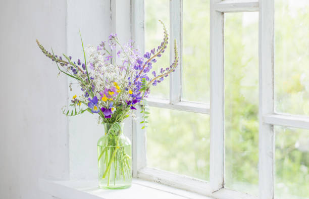 istock wild flowers in vase on white windowsill 1308051959