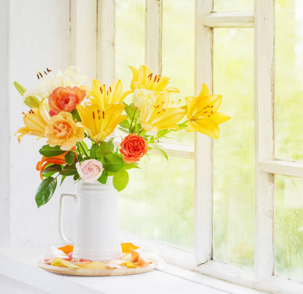 istock summer flowers in vase on background window with drops water 1308051975