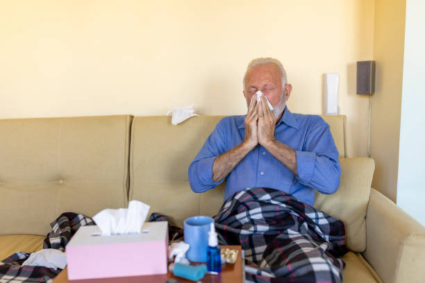 istock Sick Senior Man is Lying in the Bed Due to High Temperature and Respiratory System Problems. 1308057658