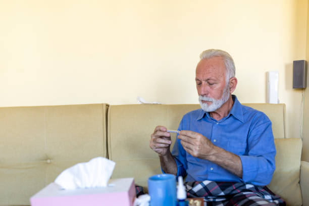 istock Sick Senior Man Caught a Flu Virus and Feeling Worried Due to High Temperature. 1308057906
