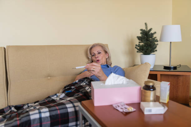istock Sick Woman is Checking the Body Temperature Due to Flu or Cold. 1308058005