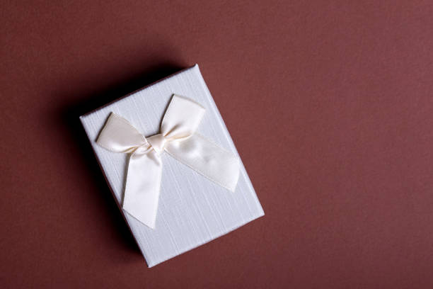 istock Craft gift box on a black background, decorated with a bow. For birthday, anniversary presents, gift post cards. 1308058209