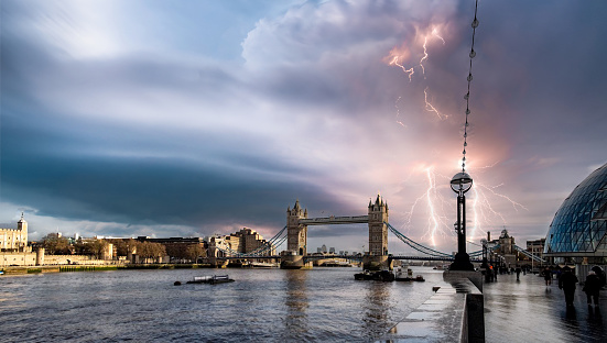 View down the river thames with the Tower bridge in view on a thunder storm evening