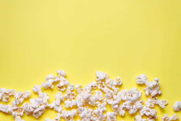 istock Home made popcorn on a yellow background 1308058894