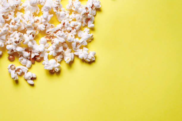 istock Home made popcorn on a yellow background 1308058919