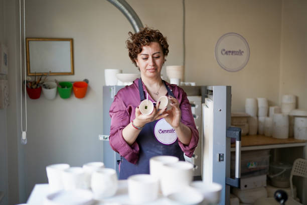 adult woman baking ceramics at her workshop - independence business women manual worker imagens e fotografias de stock