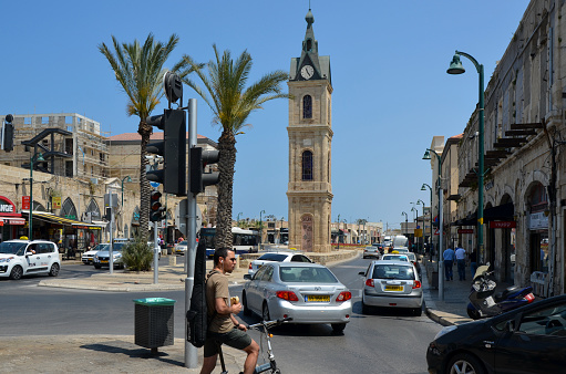 Jaffa, Isreal. - May 15, 2018: A view of Jaffa Street and famous clock tower which is one of seven clock towers built in Israel during the Ottoman period. This tower was built in honor of Sultan Abd al-Hamid II.