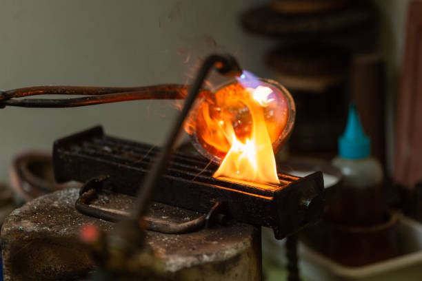 istock melting with blow torch and foundry of liquid silver from a bowl into a mold 1308063336