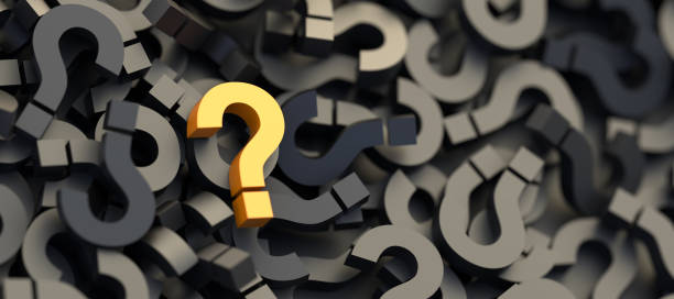 istock Yellow question mark on a background of black signs, FAQ Concept 1308063434