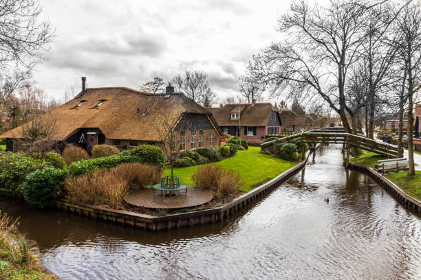 Giethoorn, The Netherlands. March, 12th 2021: Giethoorn is a town in the province of Overijssel, Netherlands with a population of 2,795 in 2020. It is located in the municipality of Steenwijkerland, about 5 km southwest of Steenwijk. As a popular Dutch tourist destination both within Netherlands and abroad, Giethoorn is often referred to as \