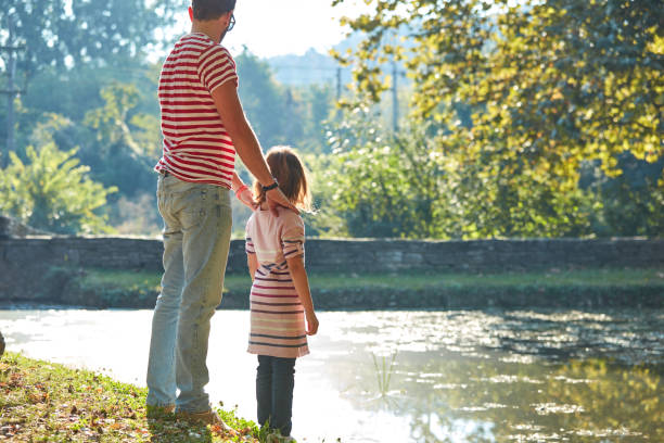 istock Daughter and father enjoying outdoors nature. 1308064623