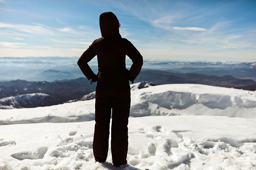 Woman enjoying on a mountain winter fresh air.