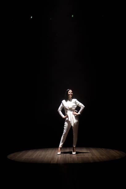 istock model in a white suit on stage in a beam of white light 1308066245
