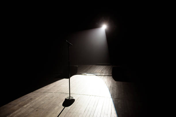 istock Microphone in a smoke on a dark background in the beam of light. 1308066628
