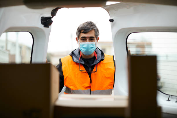 istock A delivery man opening the van doors wearing a COVID protective mask 1308067305