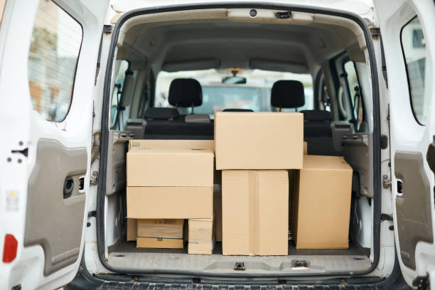 istock Rearview of a delivery van with cardboard packages 1308067309