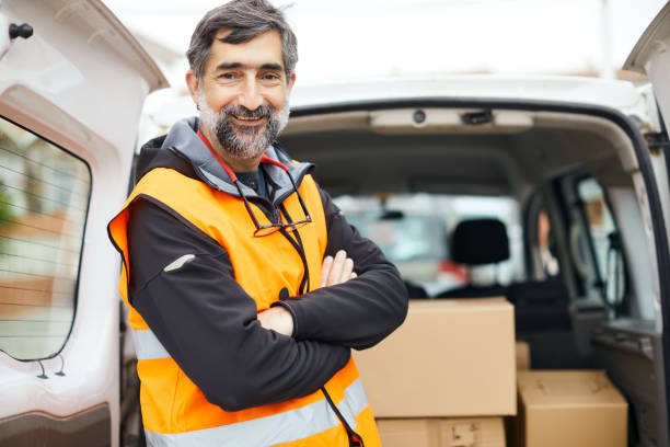 istock A middle aged delivery man portrait looking at camera. 1308067316