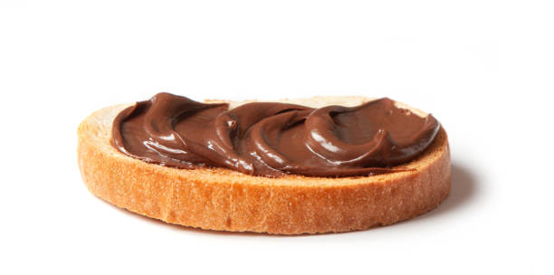 istock toasted bread with chocolate hazelnut cream isolated on white background, selective focus 1308067803
