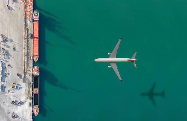istock Airplane flying above the cargo ship. 1308068622