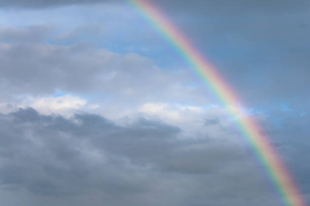 istock Rainbow formed after a storm when dark clouds begin to part, revealing a blue sky 1308070654