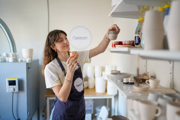 istock Beautiful Young Woman Making Ceramics at her Workshop 1308070659
