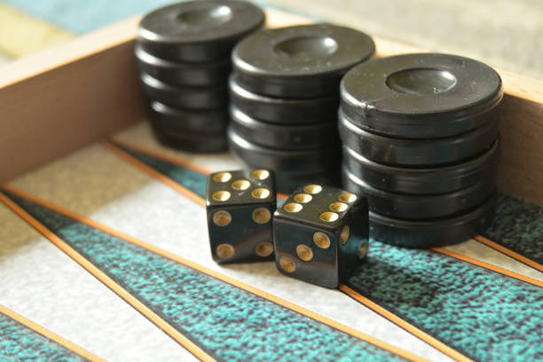 istock Close up of backgammon pieces and dices placed on the board. 1308073559