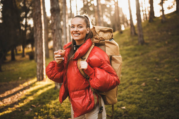 istock Female hiker eating apple and taking a break on sunrise 1308075023