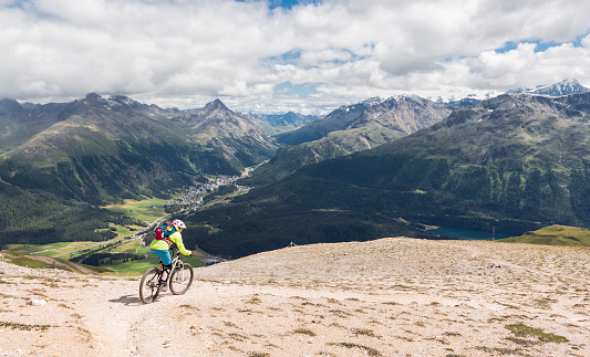 A female mountainbiker is riding on a single trail in an eroded area high above St. Moritz which is a high Alpine resort town in the Engadine in Switzerland, at an elevation of about 1,800 metres (5,910 ft) above sea level. The region is very famous for lots of outdoor activities like hiking and mountainbiking in summertime and skiing in wintertime.
Canon EOS 5D Mark III, 1/500, f/7,1 , 24 mm.