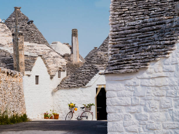 Stunning alley of the village of Alberobello with traditional trulli houses, Apulia region, southern Italy stock photo