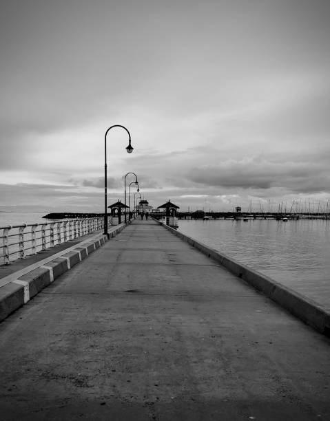 Moody Skies over the Marina Moody skies over the St Kilda Pier and Marina elevated walkway photos stock pictures, royalty-free photos & images