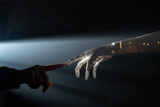 istock Human Finger Touching Robot Fingers 1308080811