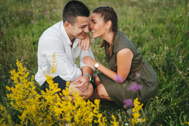 istock Beautiful young couple in summer meadow 1308081157