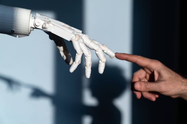 istock Human Finger Touching Robot Fingers 1308082622