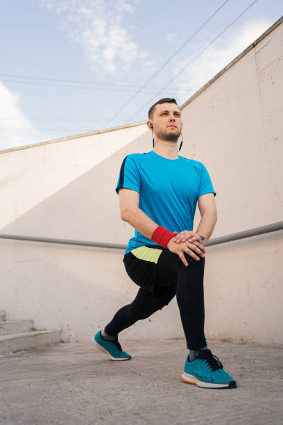 istock Caucasian man stretching city workout 1308082679