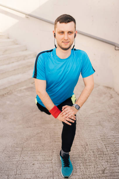 istock Caucasian man stretching city workout 1308082684