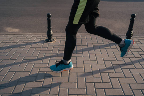 istock Fit man running legs in the city 1308082797