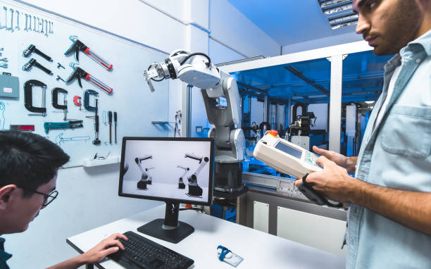 istock Engineer hand using tablet, heavy automation robot arm machine in smart factory industrial with tablet real time monitoring system application. Industry 4th iot concept. 1308083401