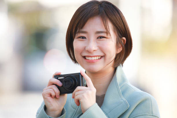 Woman taking a picture Woman taking a picture point and shoot camera stock pictures, royalty-free photos & images