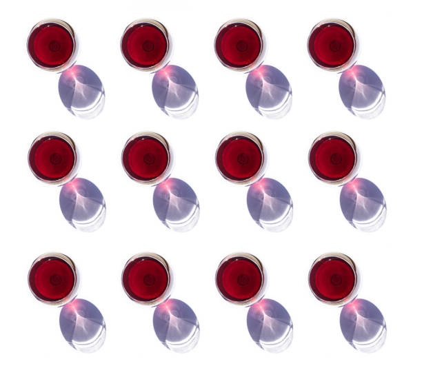 istock Pattern made of wine glasses with red wine and shadows on white background, flat lay, top view. Concept of Fashion 1308085409