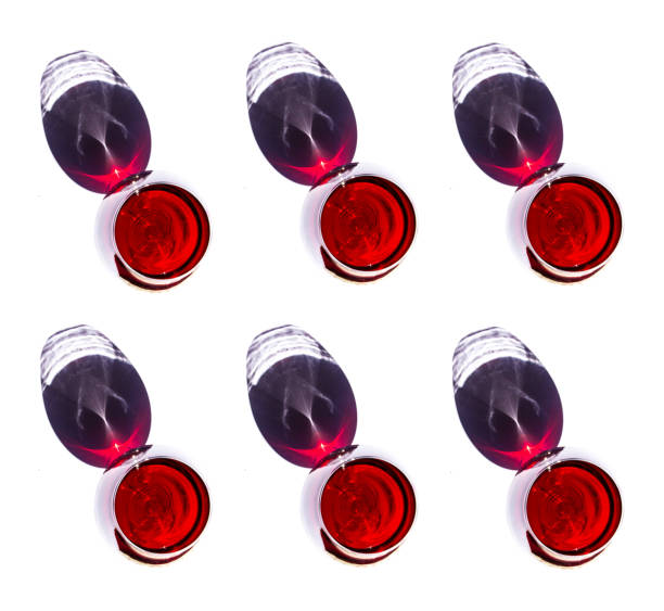istock Pattern made of wine glasses with red wine and shadows on white background, flat lay, top view. Concept of Fashion. Vibrant red color 1308085452