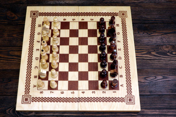 istock Chess game on a wooden background. Chess match. 1308087994